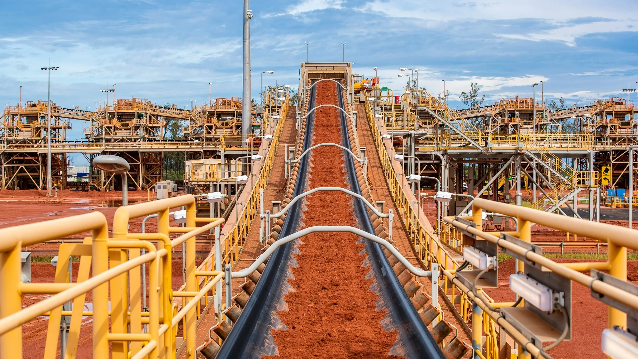 Conveyor carrying red material through the Weipa processing facility